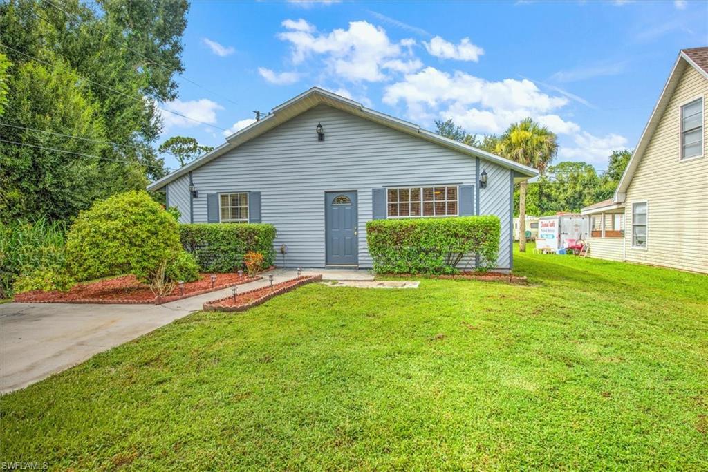 Image 2: Rear view of property featuring a lawn
