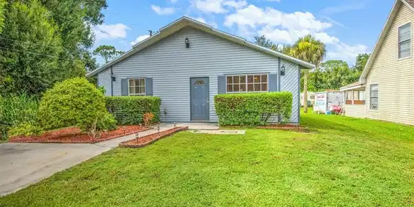 Image 2: Rear view of property featuring a lawn