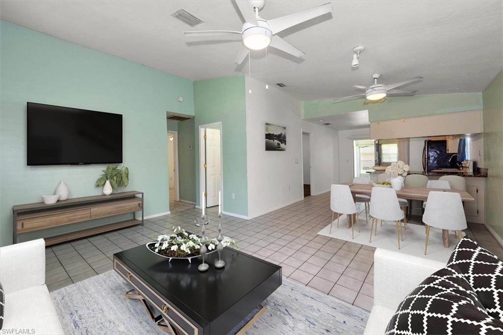 Image 3: Living area with ceiling fan and light tile patterned floors