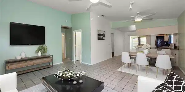 Image 3: Living area with ceiling fan and light tile patterned floors