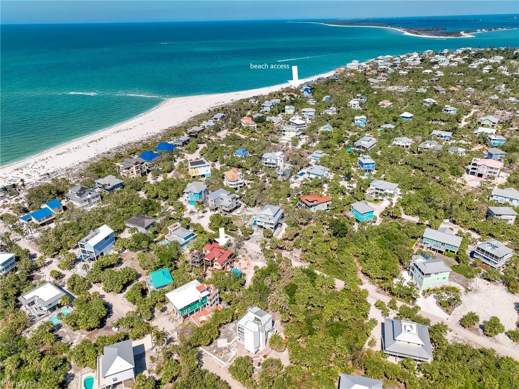 Image 4: Drone / aerial view with a water view and a view of the beach