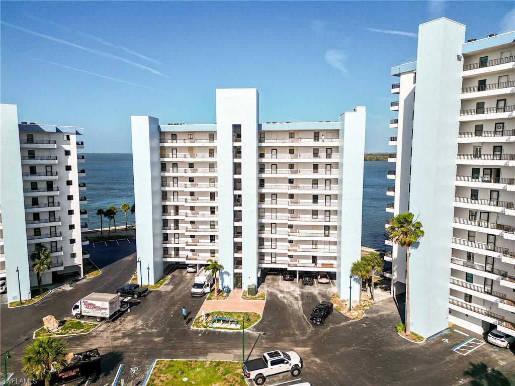 Image 2: Multi-story residential buildings featuring individual balconies and a water backdrop
