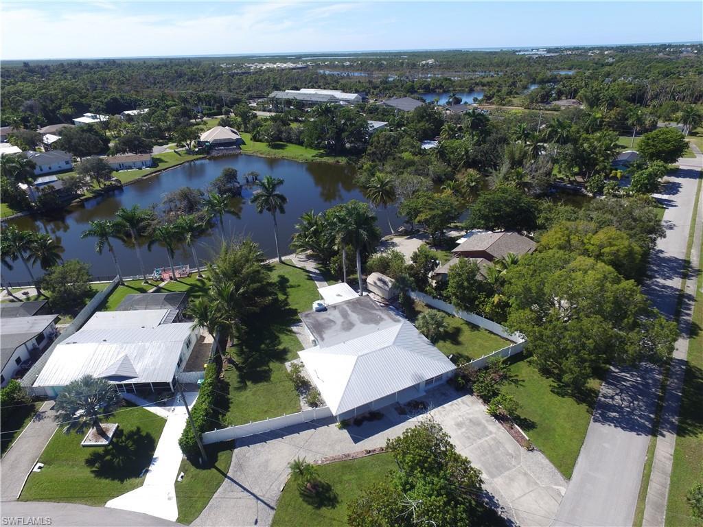 Image 1: Aerial view of residential area with a large body of water