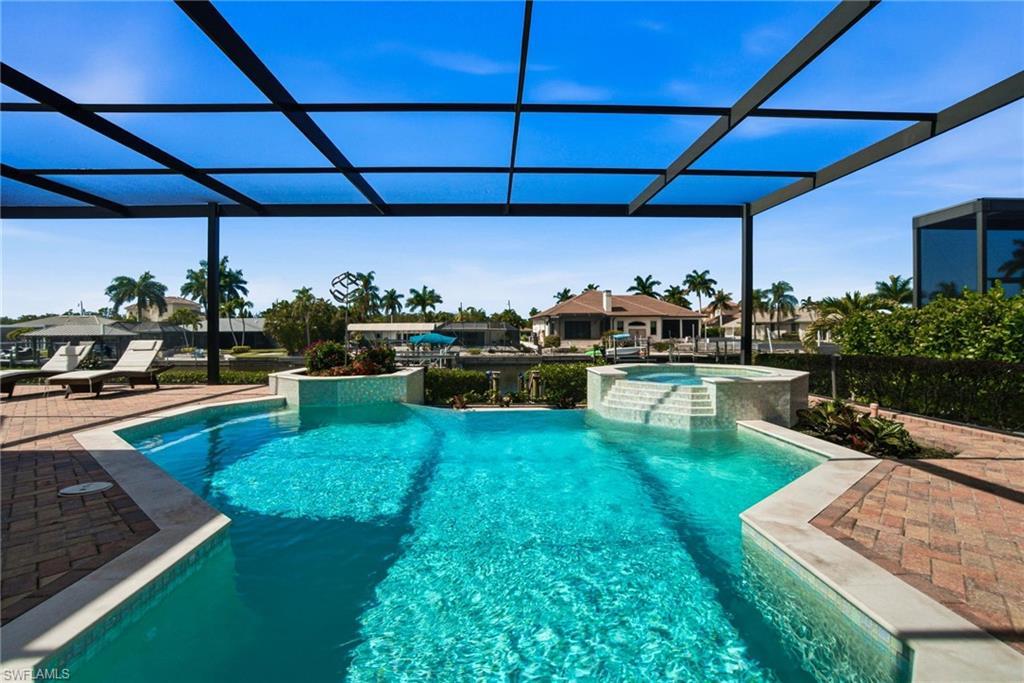 Image 3: Coveted Western exposure offers breathtaking sunsets over the water as boats sail by & dolphin splash as well as providing prime sun on your pool.