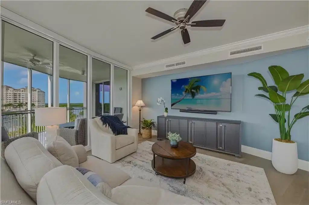 Image 1: Living room featuring a ceiling fan, floor to ceiling windows, wood finished floors, and ornamental molding