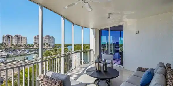 Image 4: Sunroom / solarium featuring a textured wall, floor to ceiling windows, and a water view