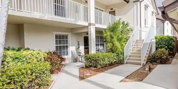 Image 2: Property entrance featuring stucco siding