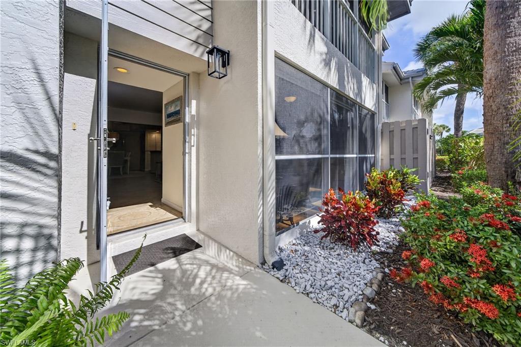 Image 4: Front walkway entry. Front door has a glassed screen door allowing for plenty of natural light.