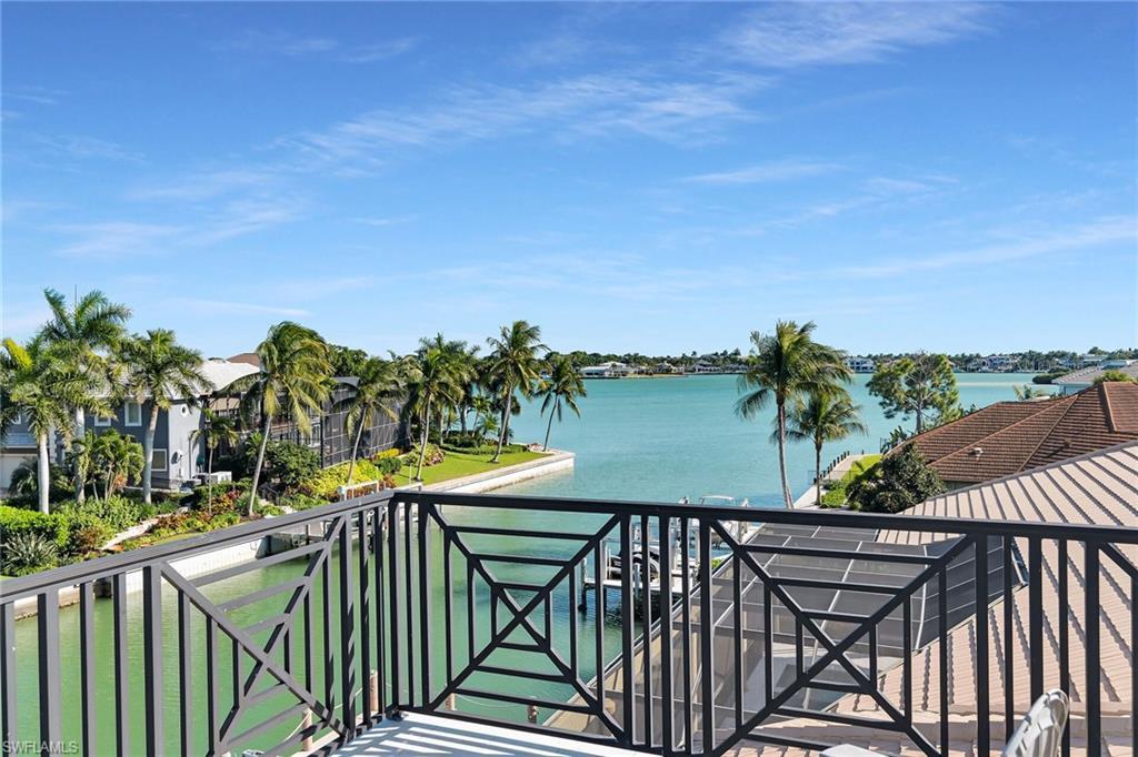 Image 3: Balcony featuring a decorative black metal railing and expansive water frontage view of  Roberts Bay