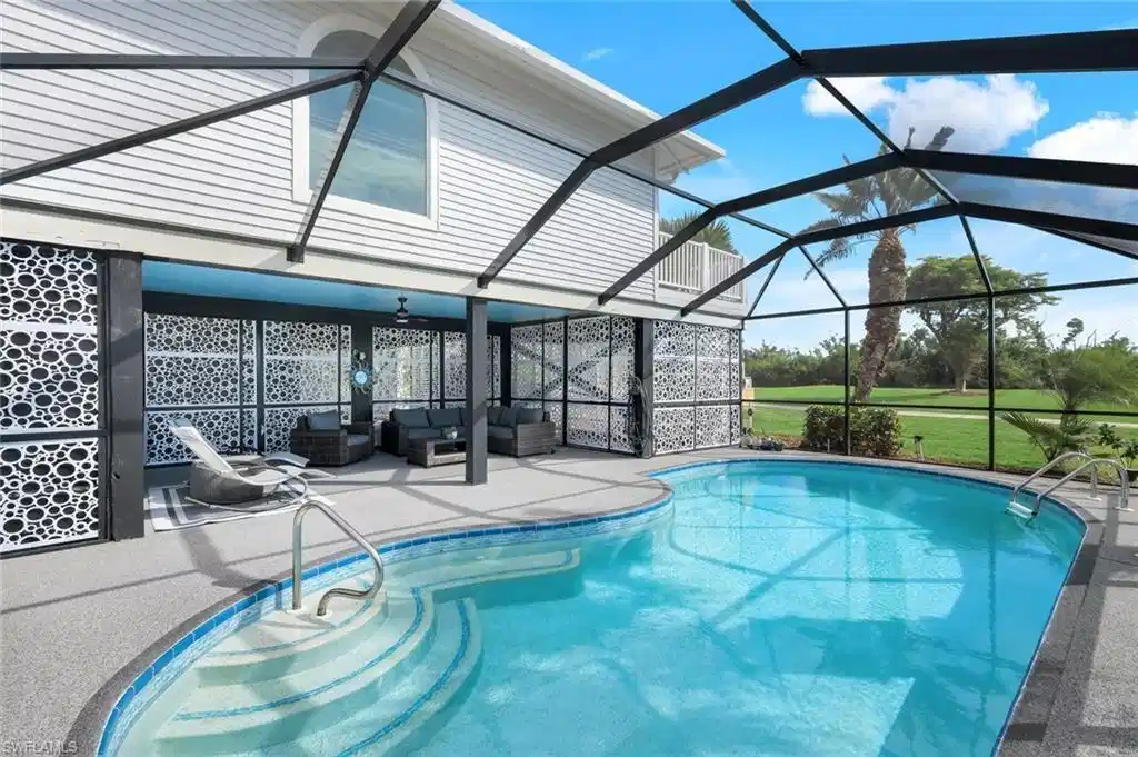 Image 1: Swimming pool featuring a sunroom, a patio area, glass enclosure, outdoor lounge area, and ceiling fan