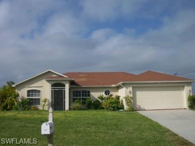 Image 1: Ranch-style house featuring a front lawn, driveway, stucco siding, and a garage