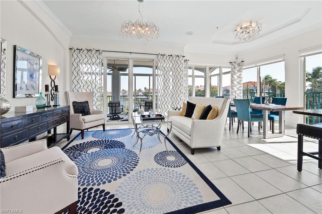Image 2: Living area featuring suspended lighting, light tile patterned flooring, and ornamental molding