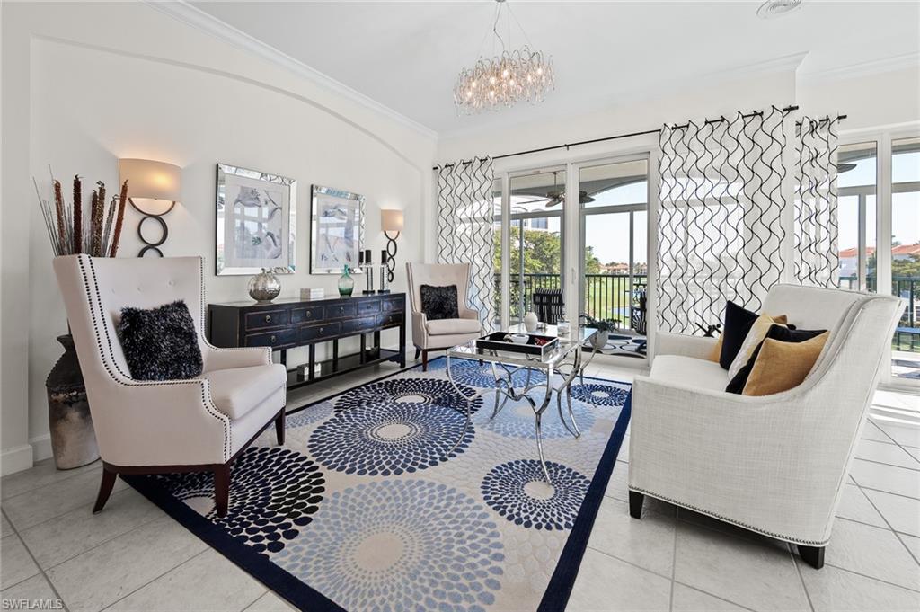 Image 3: Living area featuring ornamental molding, light tile patterned floors, and hanging lights