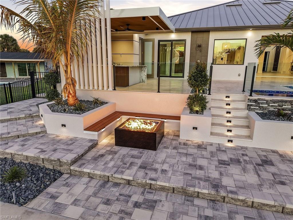 Image 4: Patio terrace at dusk featuring a patio area and an outdoor fire pit