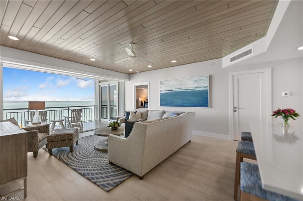 Image 4: Living area with a ceiling fan, a water view, recessed lighting, and wood ceiling