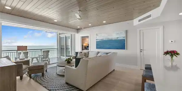 Image 4: Living area with a ceiling fan, a water view, recessed lighting, and wood ceiling