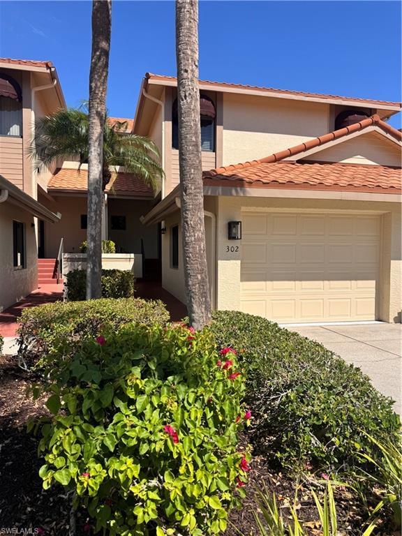 Image 1: Exterior featuring a neutral stucco finish, orange tile roofing, and an attached garage with a number '302' address plaque