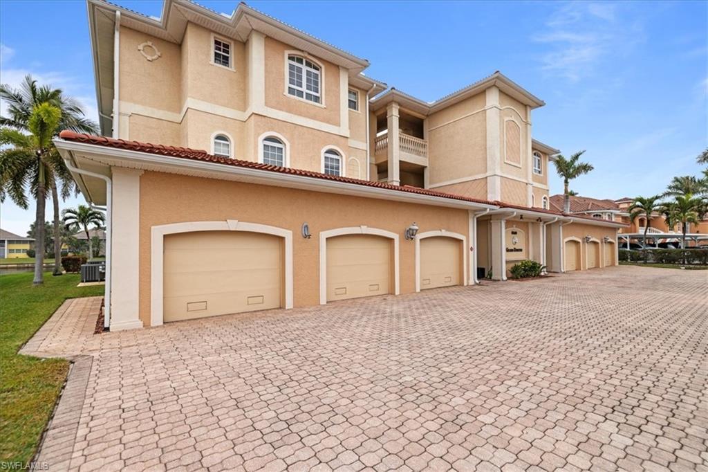 Image 2: View of front of house with central AC unit, a balcony, and a garage