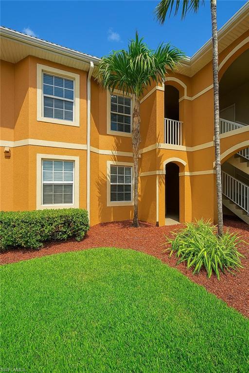 Image 1: Front of condo building view.  Unit is on the 2nd floor accessible only by stairs.