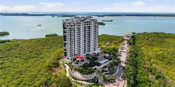 Image 4: Location of unit (see arrow). Entire end front to back. Easy walk to Bay Club next door.