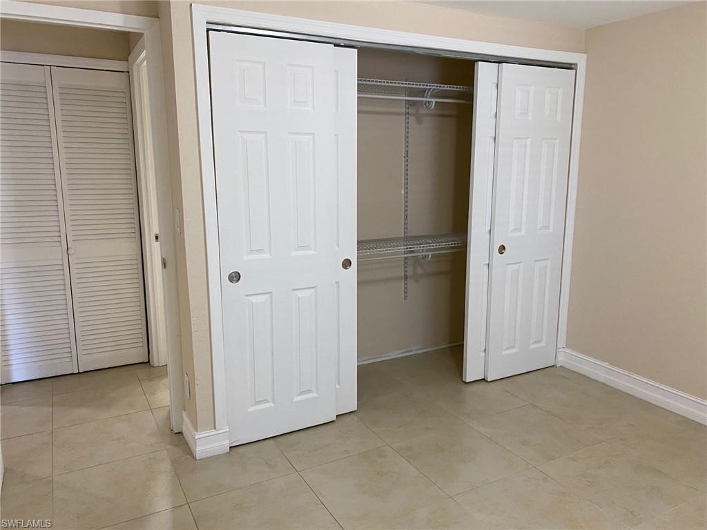 Image 4: Unfurnished bedroom featuring light tile patterned floors and a closet