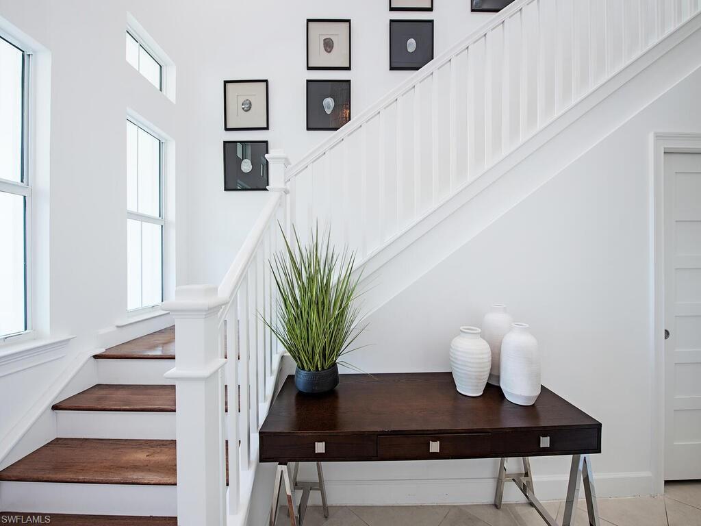 Image 3: Staircase with tile patterned flooring and baseboards