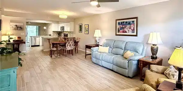 Image 3: Living area with light wood-type flooring and ceiling fan