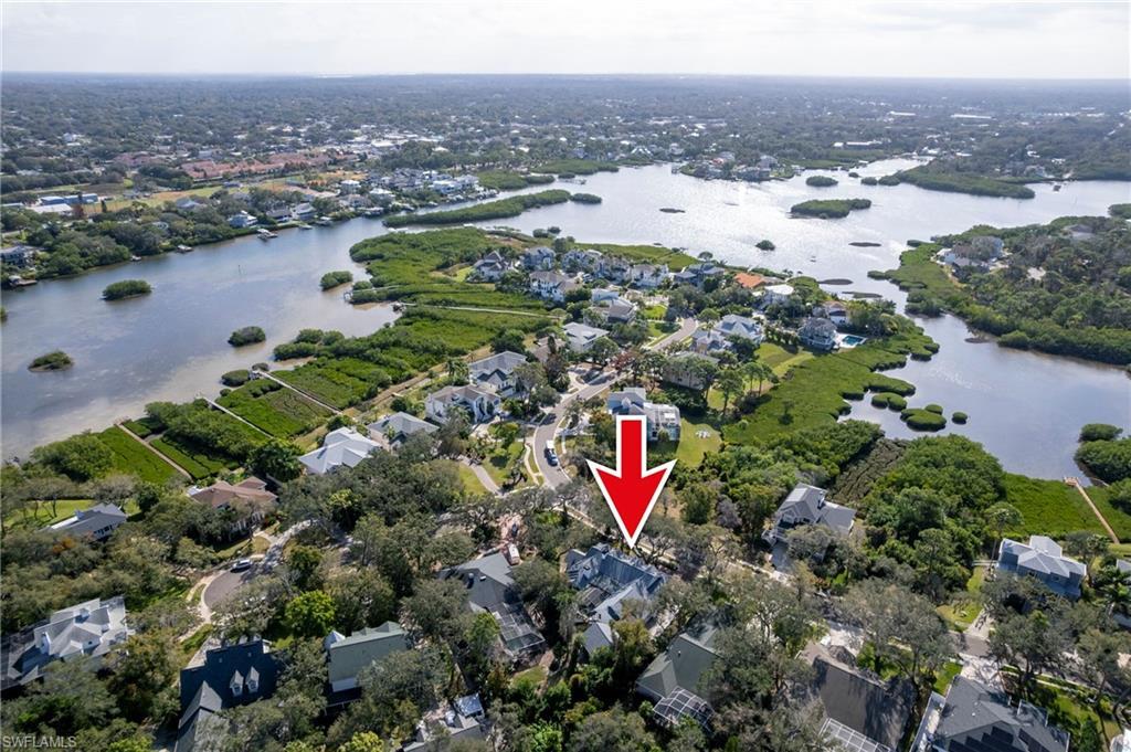 Image 3: Aerial view of property and surrounding area featuring nearby suburban area and a nearby body of water