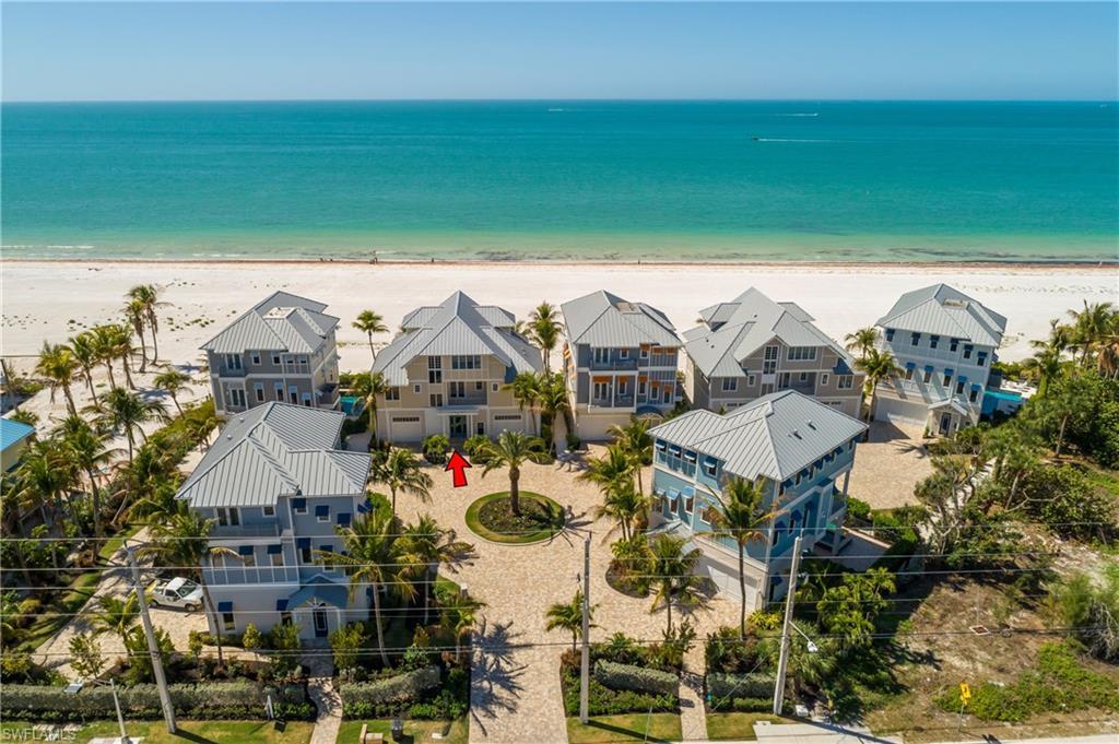 Image 4: Aerial view of residential area featuring extended coastline