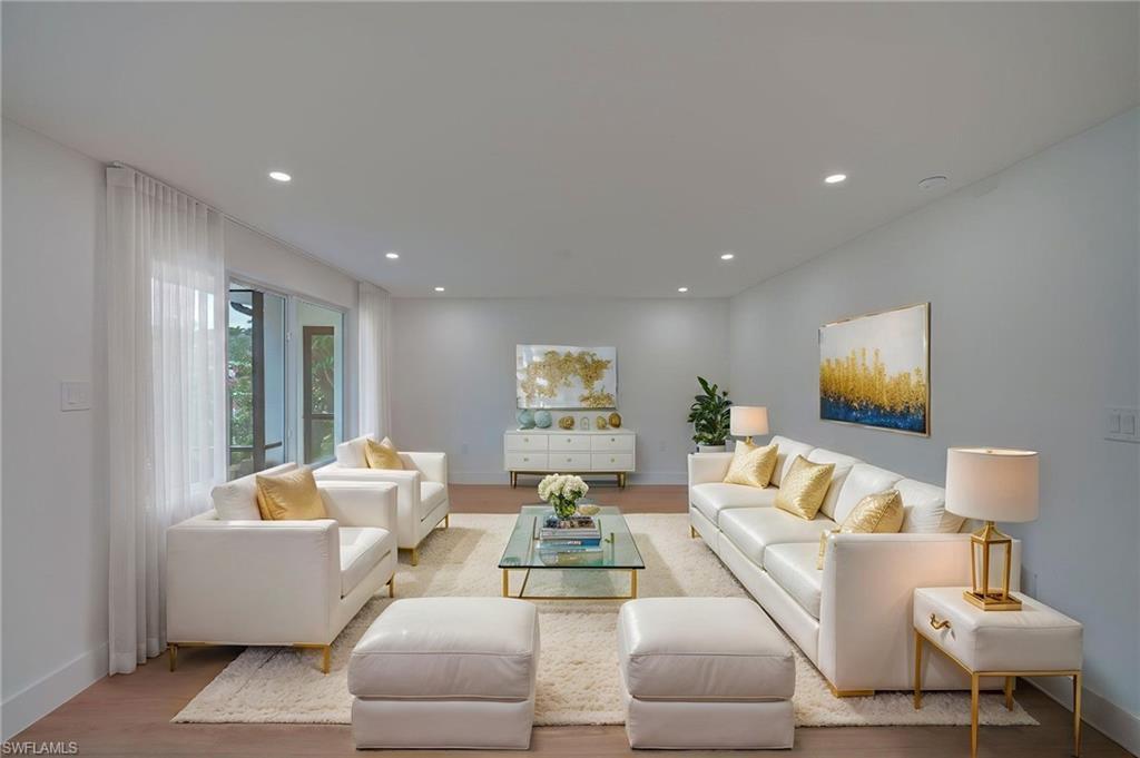 Image 3: Spacious living room featuring wood-finish flooring and recessed lighting