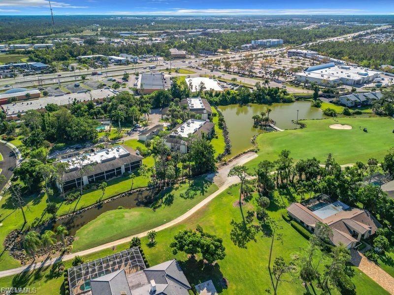 Image 3: Aerial view of property's location with a nearby body of water and a golf course