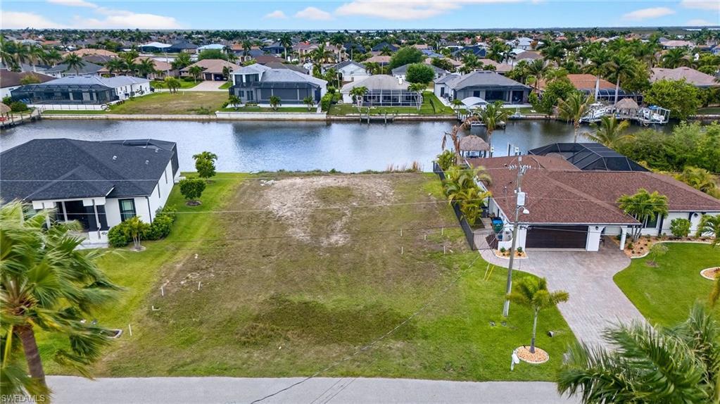 Image 1: Aerial view of residential area with a large body of water