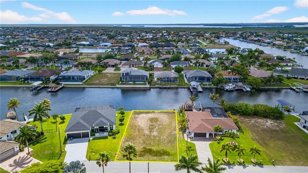 Image 3: Aerial perspective of suburban area with property boundaries highlighted and a large body of water