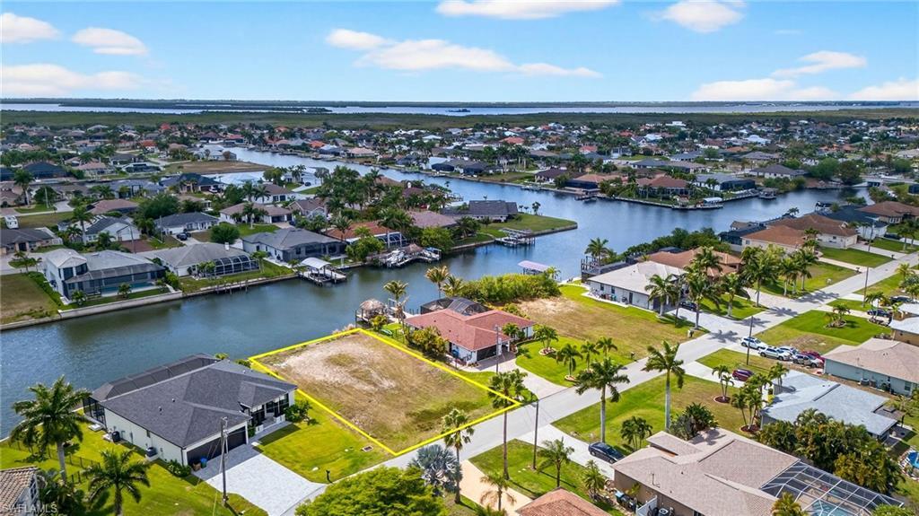 Image 4: Aerial view of residential area with a large body of water