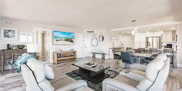 Image 4: Living room with a chandelier and light hardwood / wood-style floors