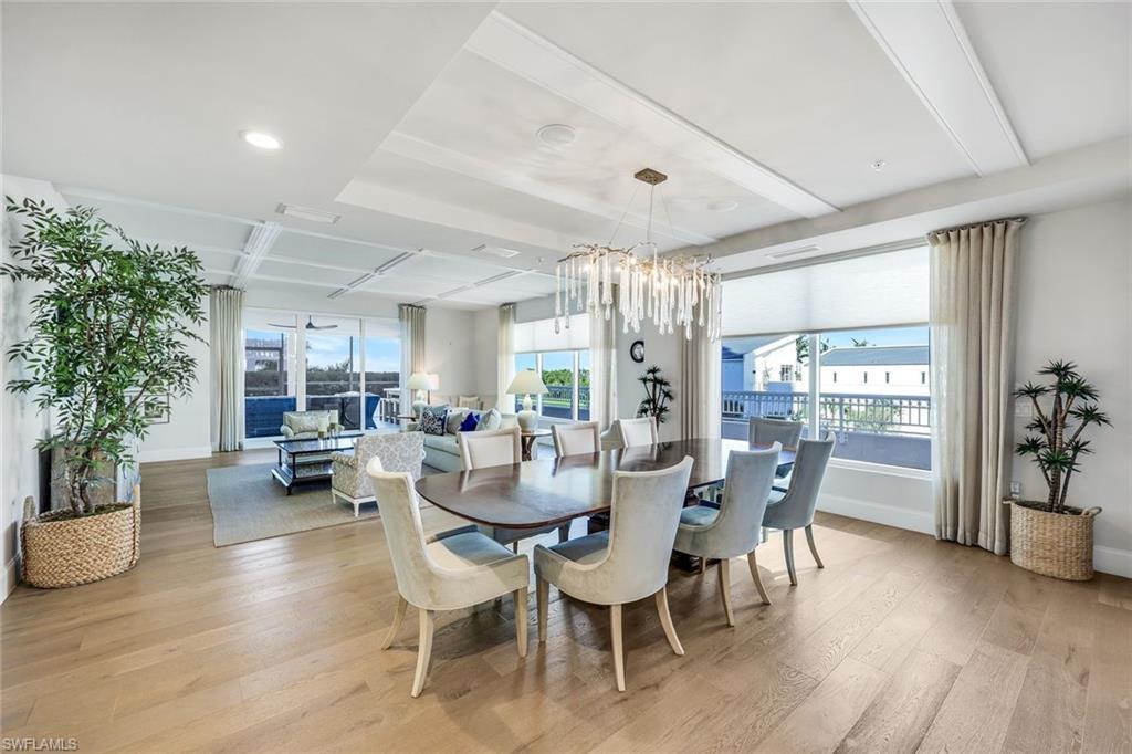 Image 4: Floor to ceiling windows, rich wood plank flooring, custom lighting and so much more!