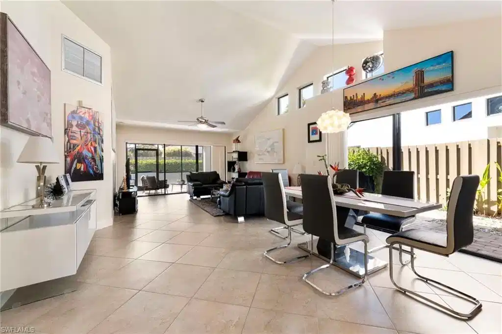 Image 1: Dining area featuring a high ceiling, ceiling fan, and light tile patterned floors