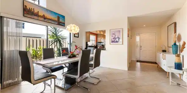 Image 3: Dining space featuring lofted ceiling and light tile patterned floors