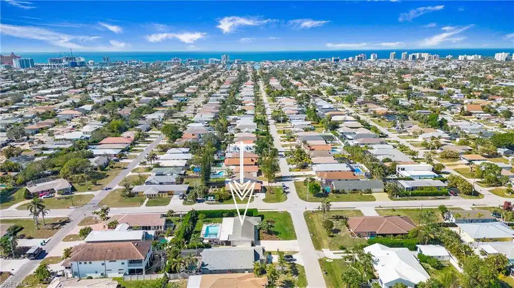 Image 1: View of urban area featuring nearby suburban area and a nearby body of water