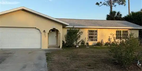 Image 2: Ranch-style home with stucco siding, concrete driveway, a garage, and a front lawn