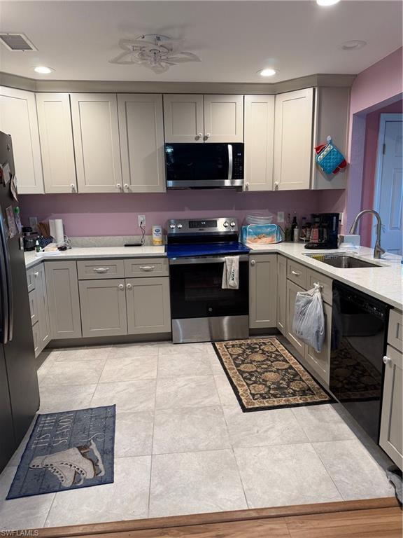Image 3: Kitchen with gray cabinetry, stainless steel electric range oven, a ceiling fan, dishwashing machine, and fridge
