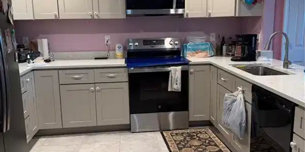 Image 3: Kitchen with gray cabinetry, stainless steel electric range oven, a ceiling fan, dishwashing machine, and fridge