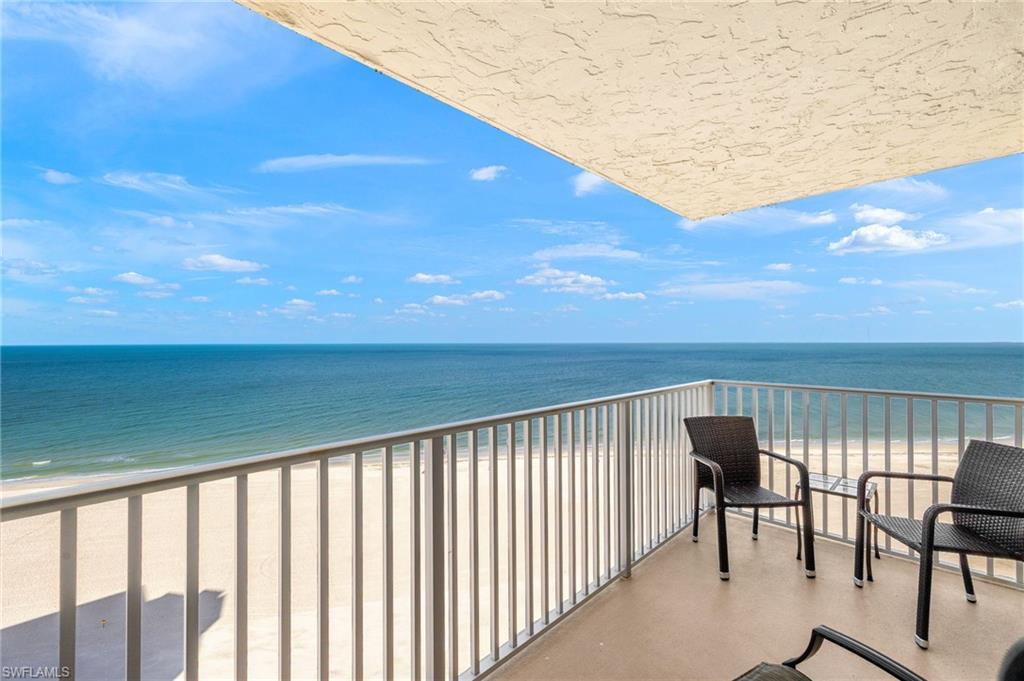 Image 1: Balcony featuring view of water and beach
