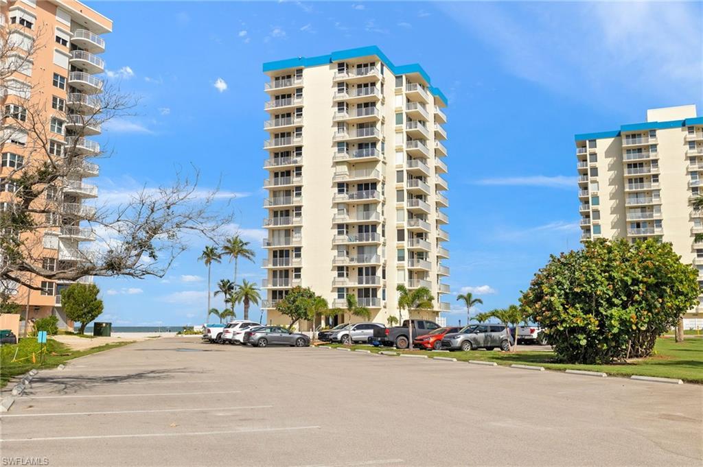 Image 3: View of apartment building / complex featuring uncovered parking