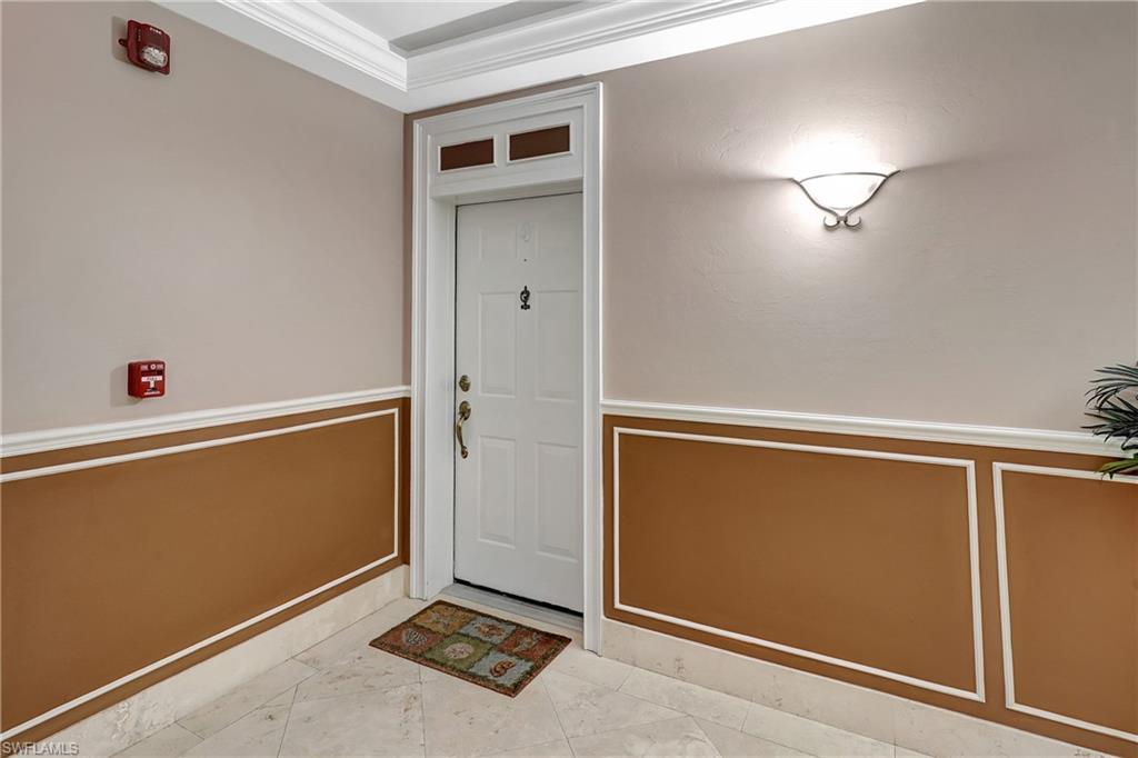 Image 3: Living area featuring crown molding, a ceiling fan, hanging lights, and light tile patterned floors