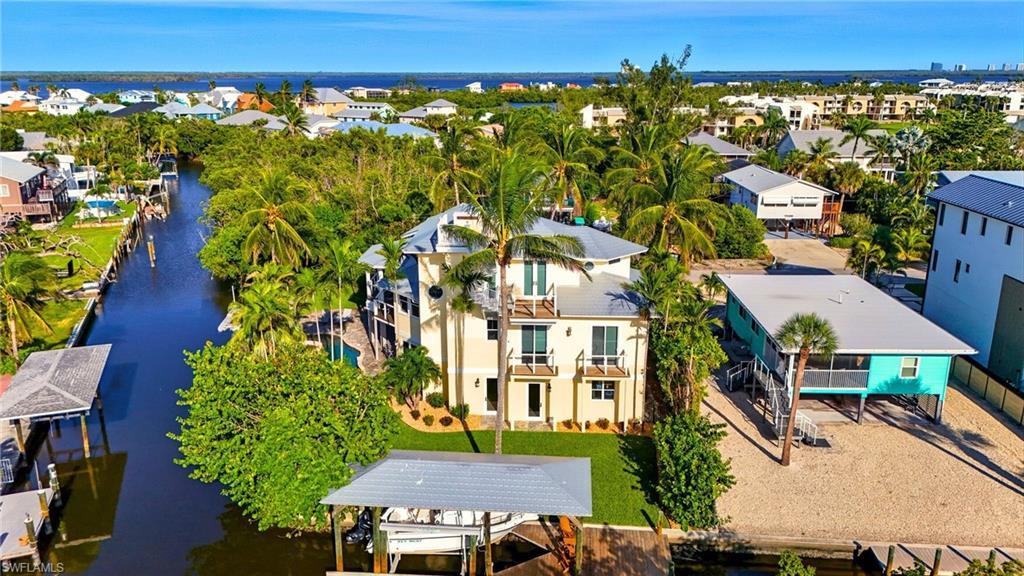 Image 2: Balcony featuring boat lift and a water view - Virtually Edited Image