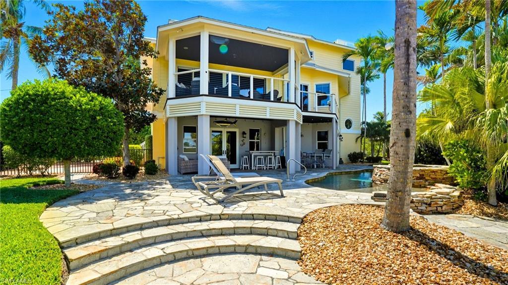 Image 3: Back of house with a patio, ceiling fan, and a balcony - Virtually Edited Image