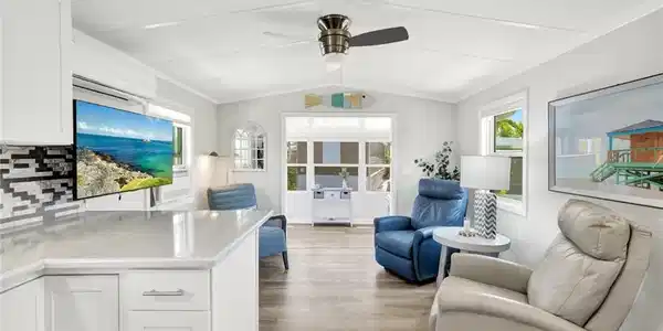 Image 2: View of living area and enclosed porch from kitchen.