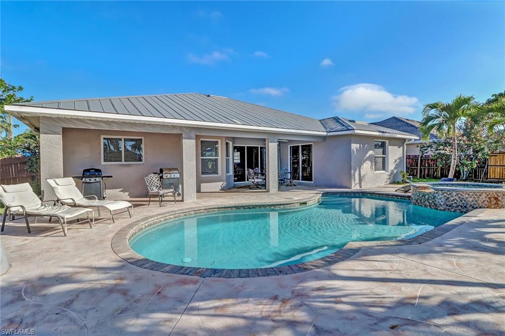 Image 4: Fenced backyard with a patio area, ceiling fan, area for grilling, and outdoor dining area