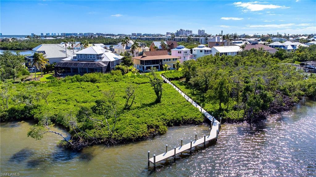 Image 3: Drone / aerial view of the private dock through trimmed mangroves at Estero Bay preserve